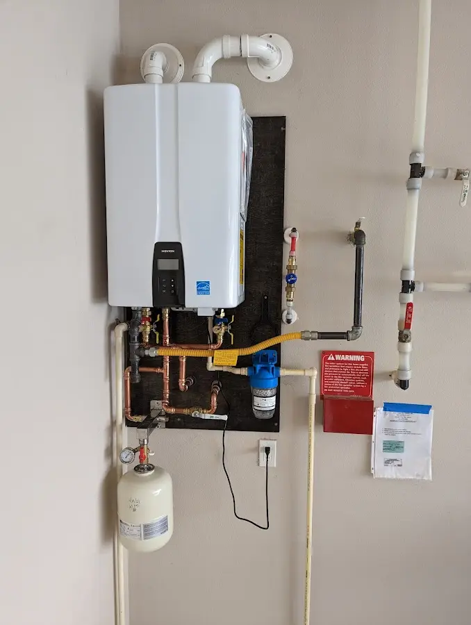 Professional plumber installing copper piping in a Palatine home